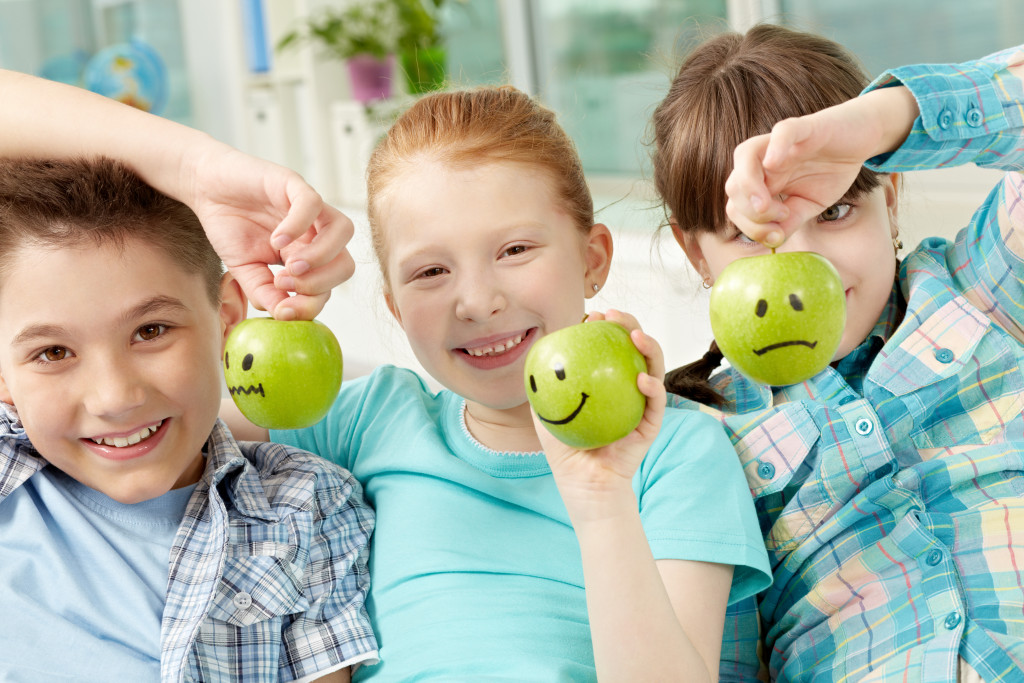 Children holding apples