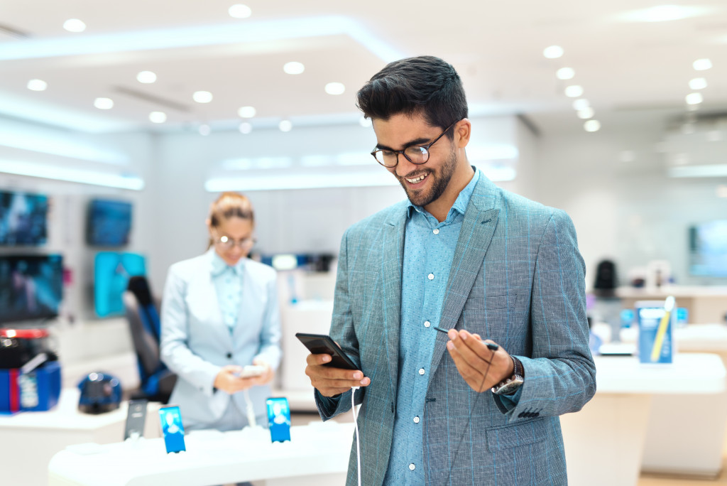 man holding phone in store