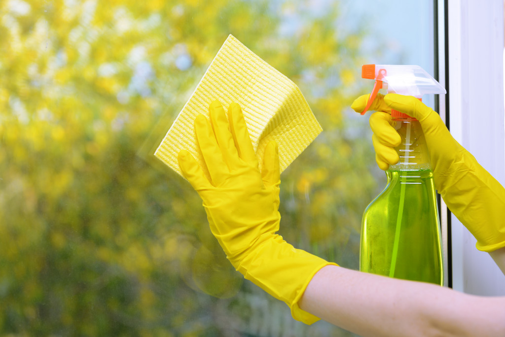 wiping the window with cleaning solution