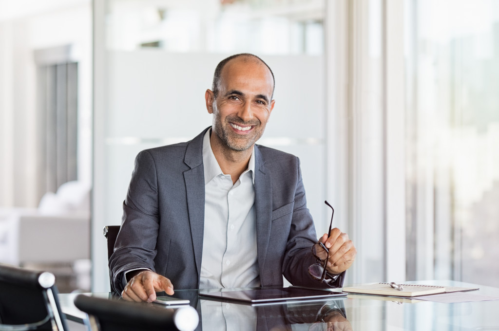 man working in office, smiling in the meeting room