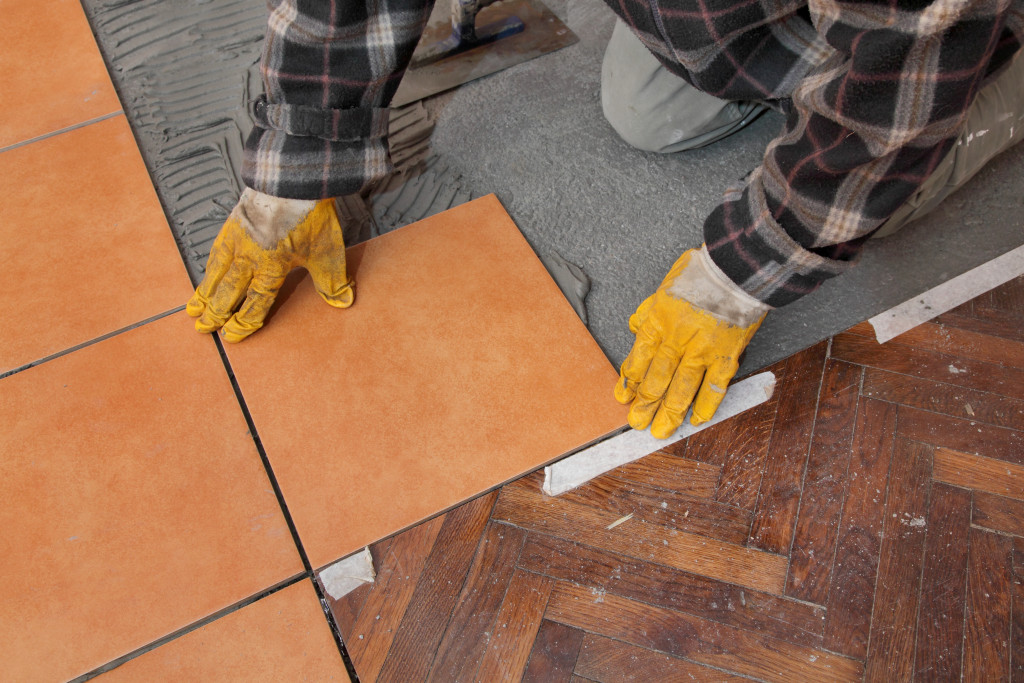 installation of new orange tiles in a flooring