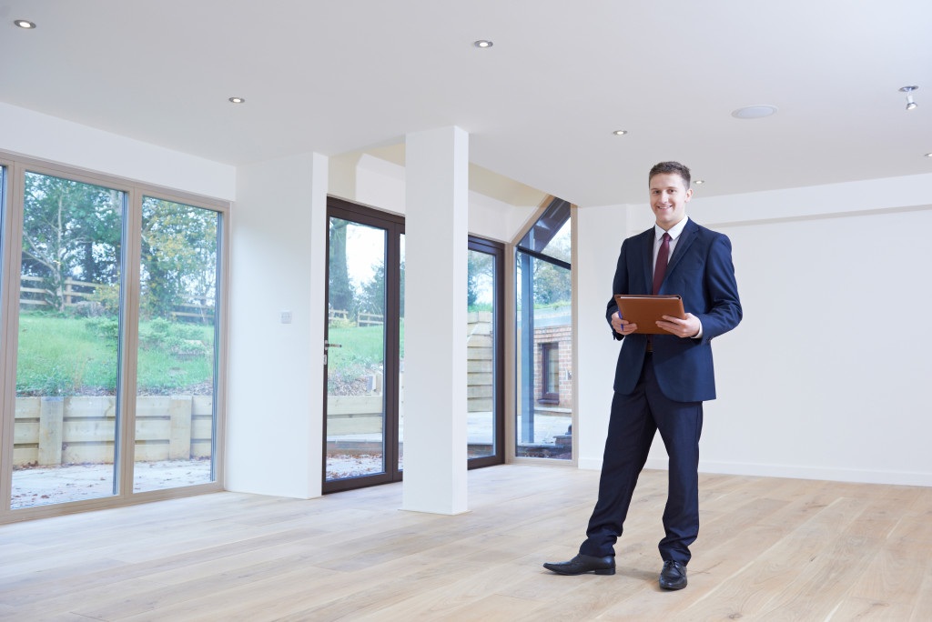 man in a suit inside an empty house