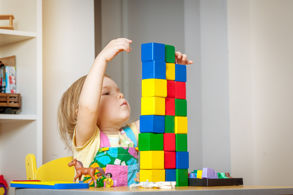 Little girl playing with blocks