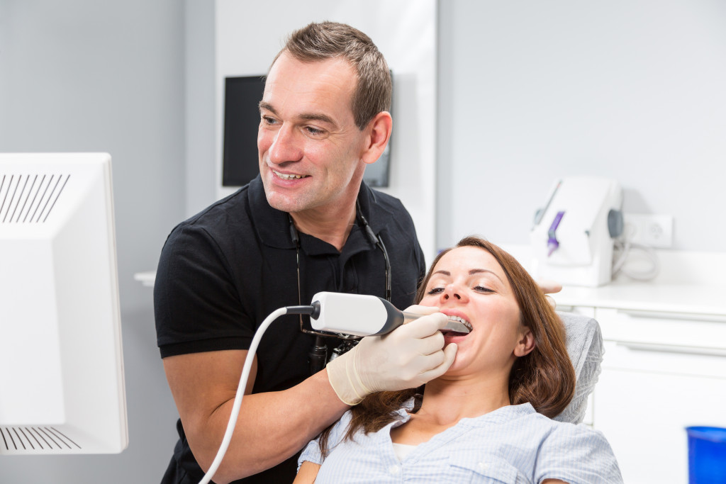 dentist scanning his patients teeth