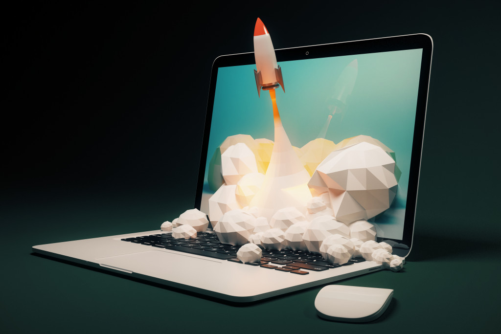 A space rocket launching in front of a laptop