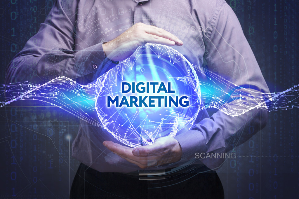 Person holding a representation of a globe showing digital marketing.