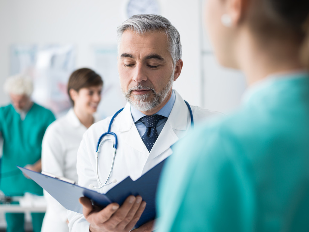 A doctor and hospital employees wearing scrubs