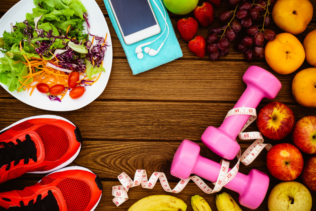 Fruits, gym equipment, salad, and a smartphone