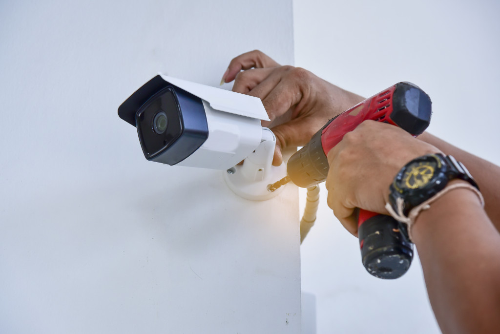 A homeowner installing a security camera