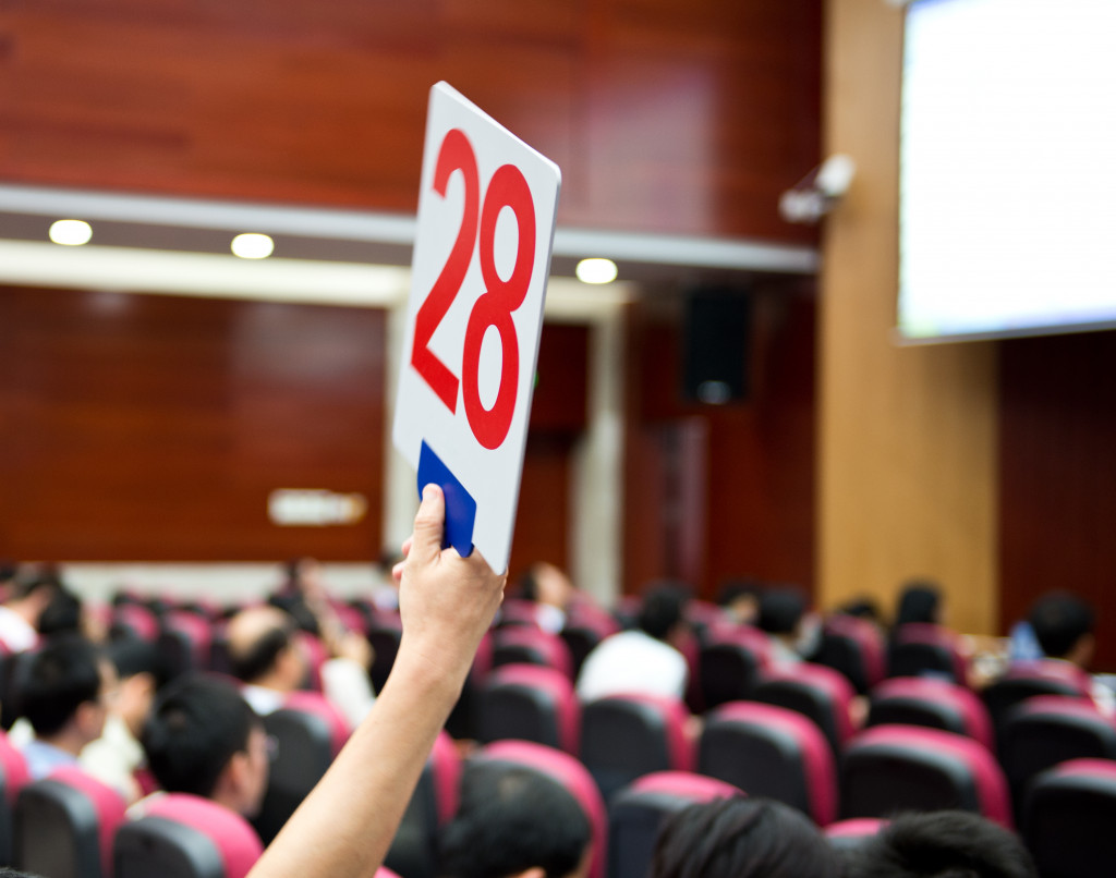 A Person Holding Up A Number at an Auction