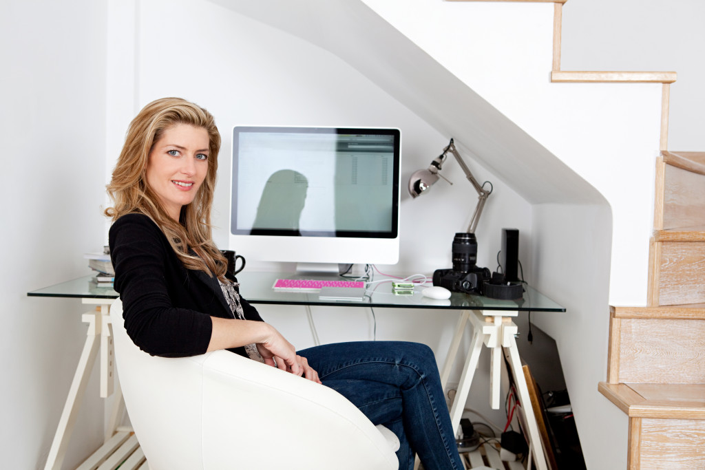 Young woman working at a designated workspace at home.