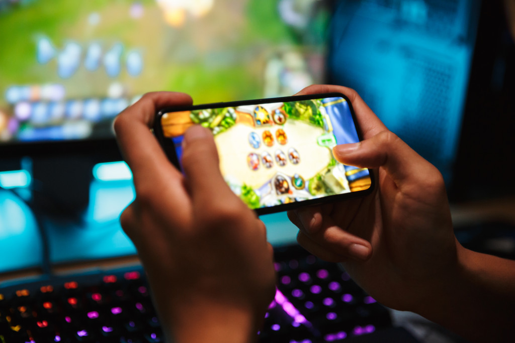 a person playing mobile games