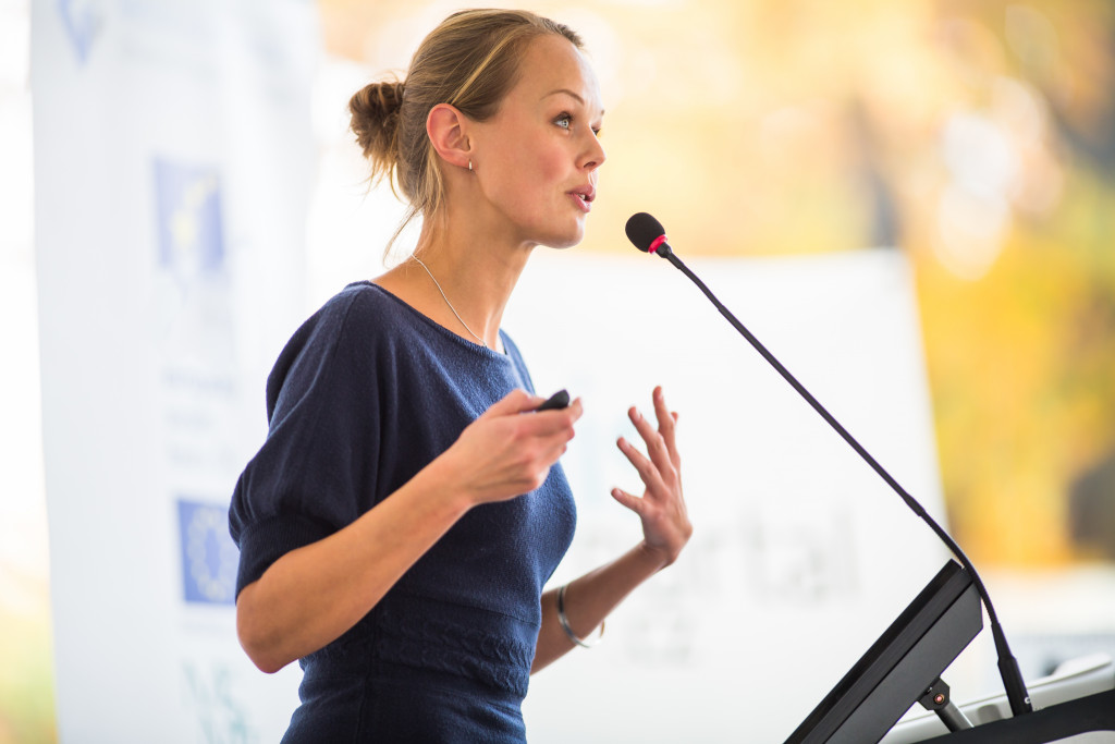 a woman speaking in a conference 