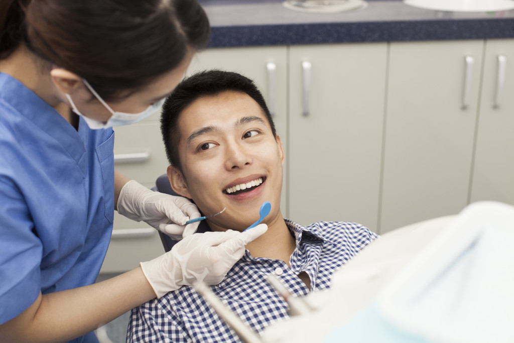 a dentist checking a man's teeth