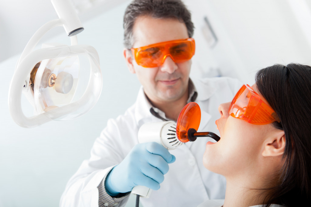 dentist using laser on a female patient