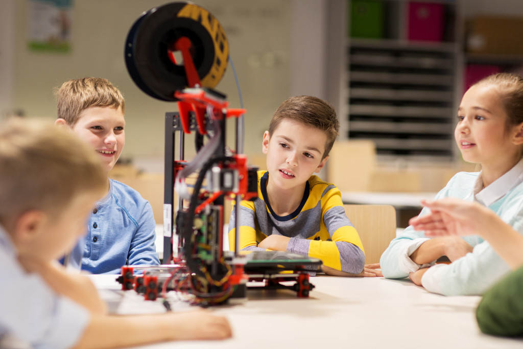 Children checking out a 3d printer