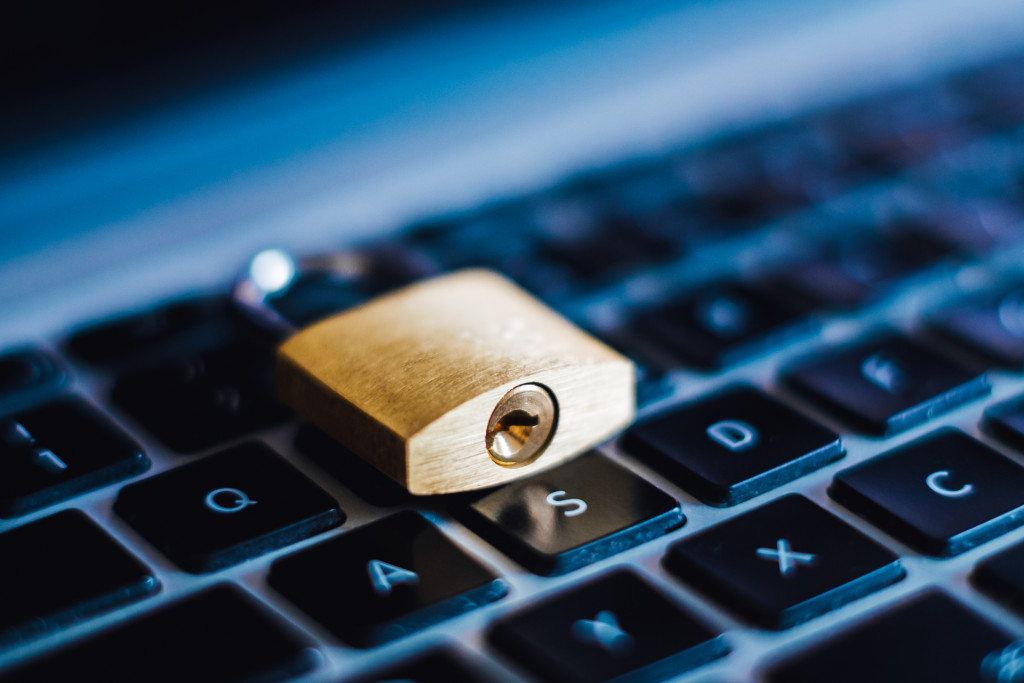 a lock is shown on top of a keyboard as a symbol of data privacy protection