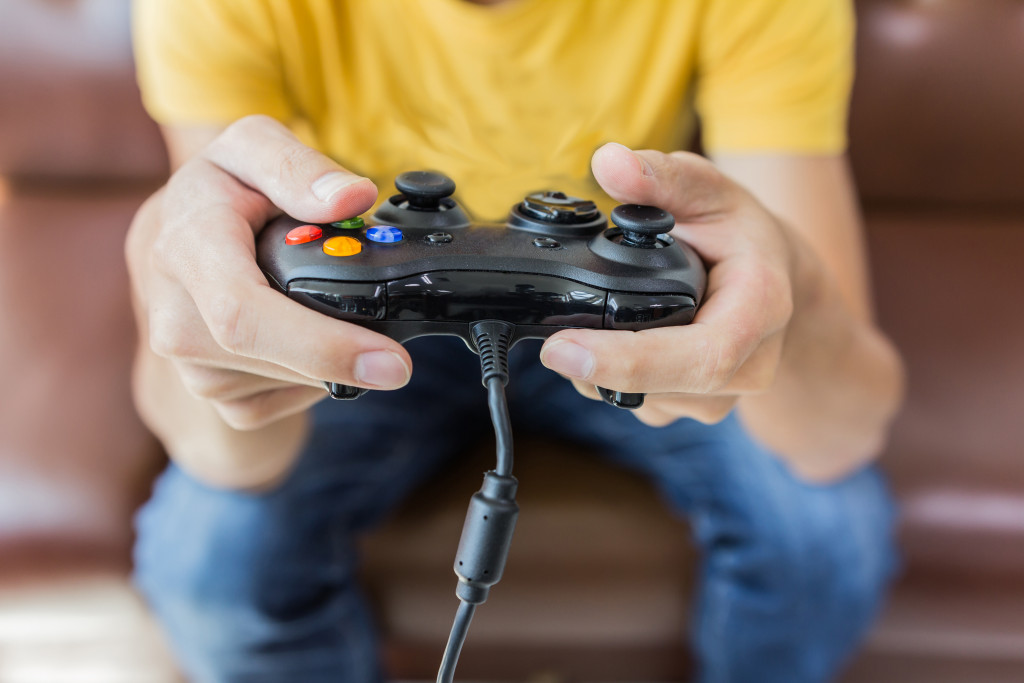 A boy playing a video game with controller