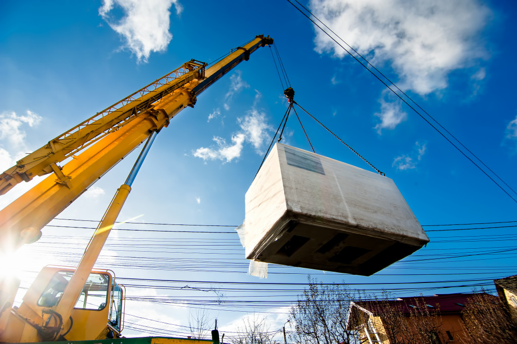 a crane lifting a generator on site