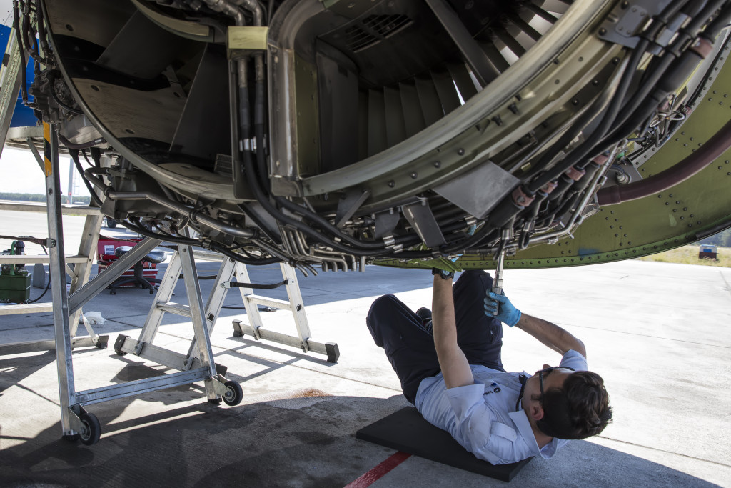 An aircraft engineer repairing an airplane