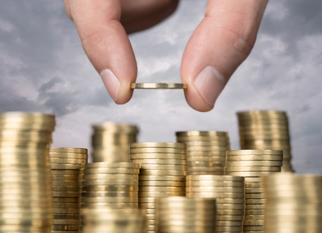 Person stacking gold coins