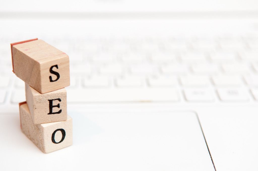 Letter blocks forming SEO word on white laptop keyboard