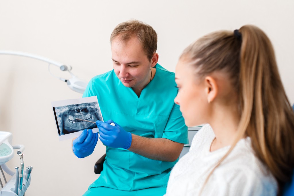 dentist showing patient her dental xray