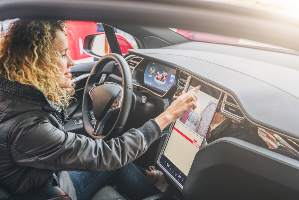 woman driver her car navigating tablet