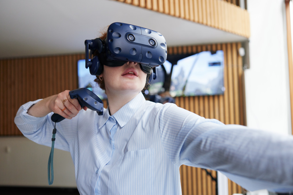 woman wearing VR goggles digital tech