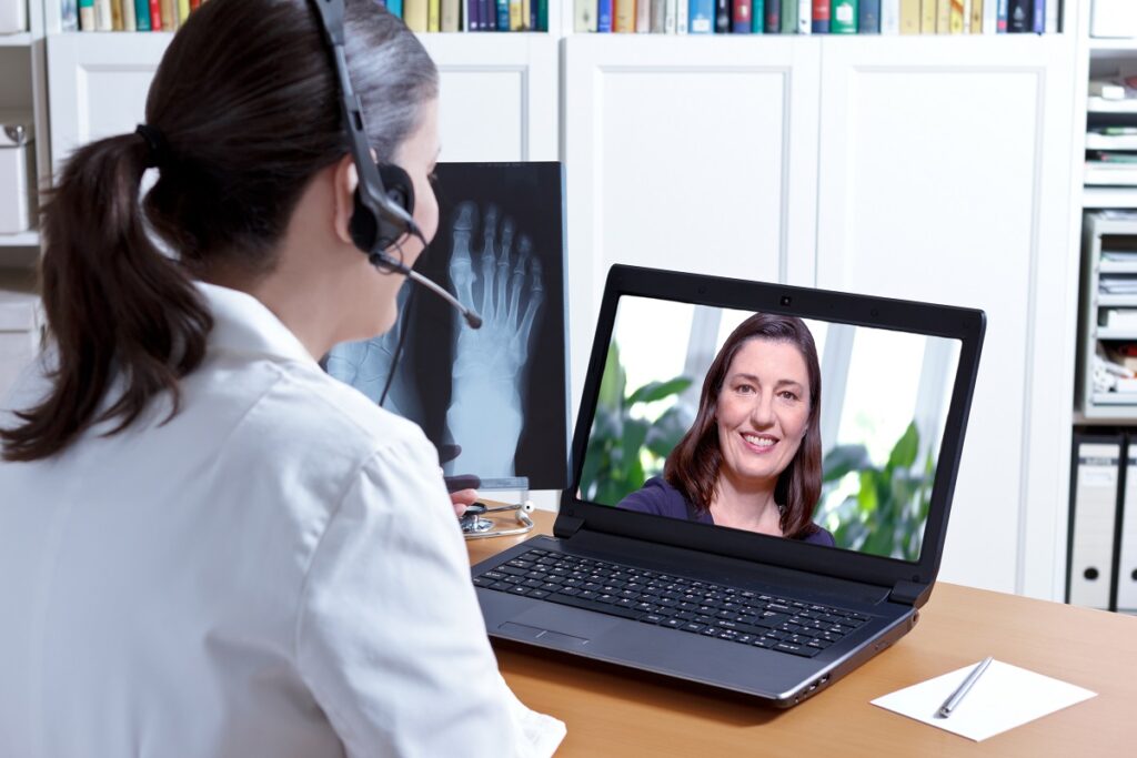 A doctor having a video conference meeting with a patient
