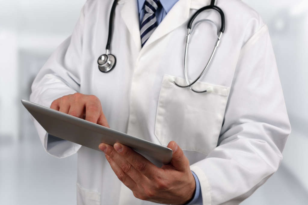 medicine represented by doctor using tablet