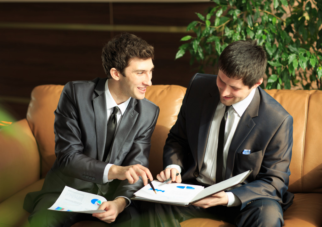 two men discussing project at meeting